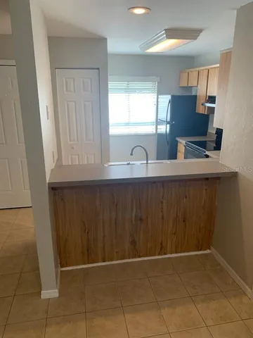 a kitchen with a sink a window and cabinets