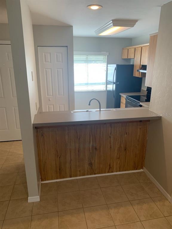 6206 Southwest 8th Lane Gainesville, FL 32607 - Photo 7 of 15 a kitchen with a sink a window and cabinets