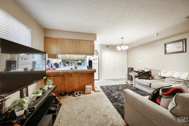 a kitchen with stainless steel appliances granite countertop a refrigerator a stove a sink and dishwasher