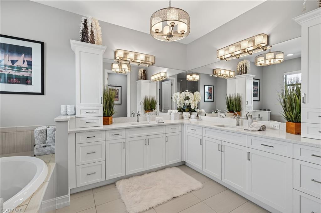 14690 Reserve Place Naples, FL 34109 - Photo 30 of 48 Full bathroom with double vanity, a bath, and light tile patterned flooring
