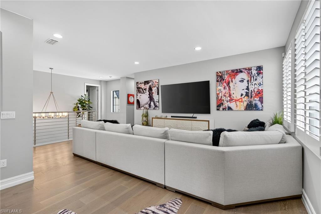 14690 Reserve Place Naples, FL 34109 - Photo 31 of 48 Living area with light wood-style flooring, recessed lighting, and a chandelier