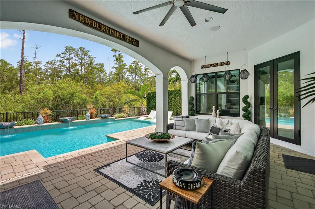 14690 Reserve Place Naples, FL 34109 - Photo 39 of 48 View of swimming pool featuring a patio, an outdoor living space, a ceiling fan, and french doors