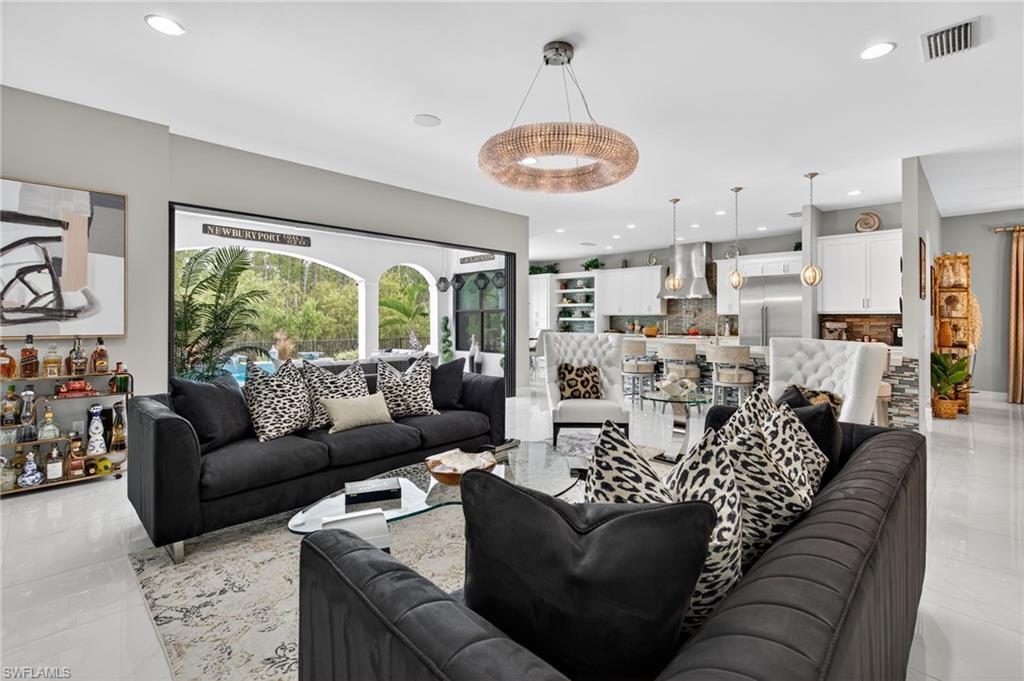 14690 Reserve Place Naples, FL 34109 - Photo 8 of 48 Living room with light tile patterned floors and recessed lighting