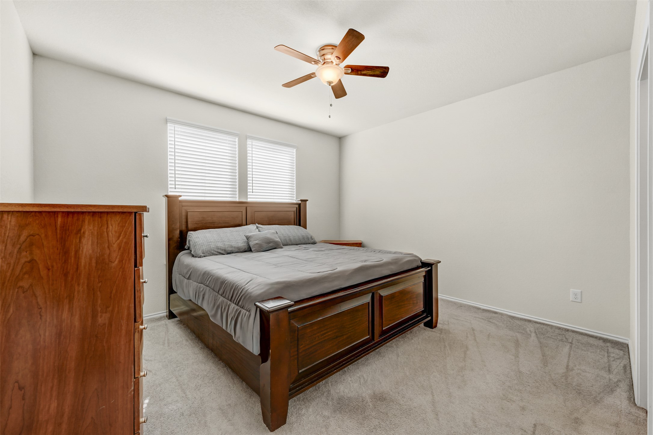 213 Ibis Falls Loop Jarrell, TX 76537 - Photo 15 of 37 Relax in this well-appointed sleeping sanctuary, featuring a soothing neutral palette and overhead air circulation.