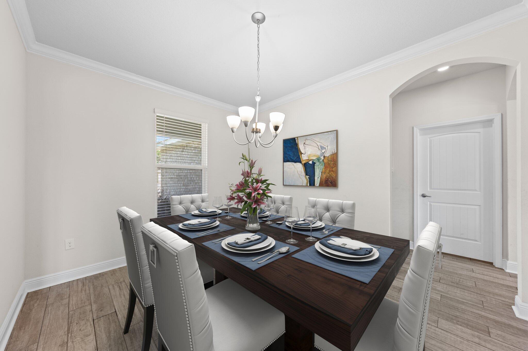 91 Sweet Tea Lane Freeport, FL 32439 - Photo 16 of 80 a view of a dining room with furniture wooden floor and chandelier