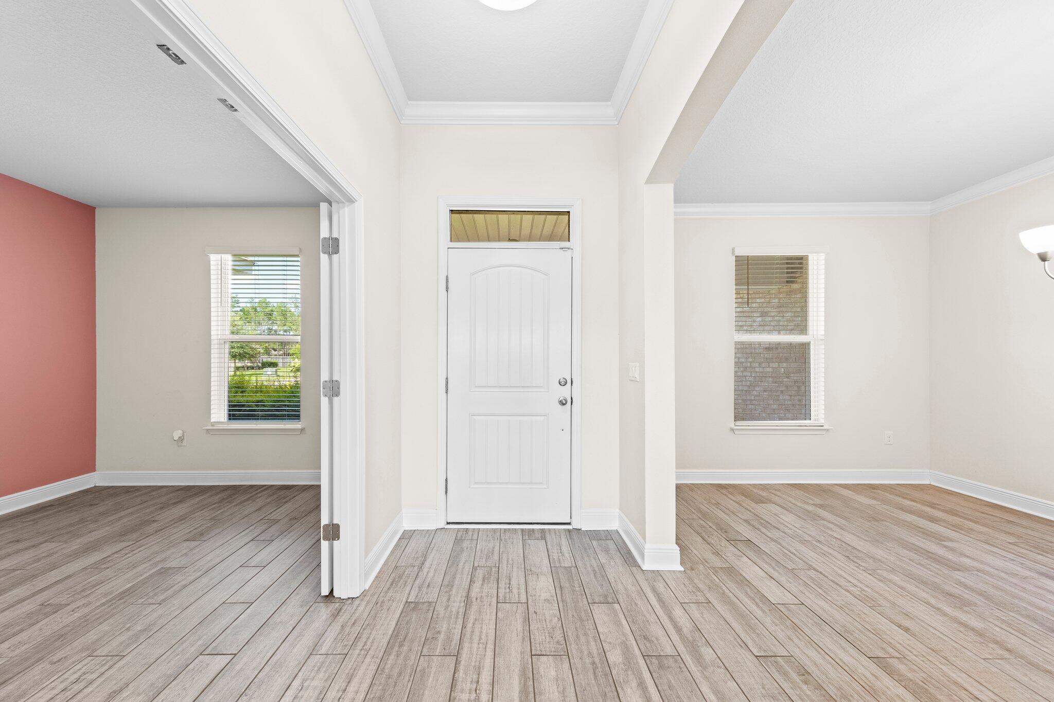 91 Sweet Tea Lane Freeport, FL 32439 - Photo 20 of 80 an empty room with wooden floor and windows
