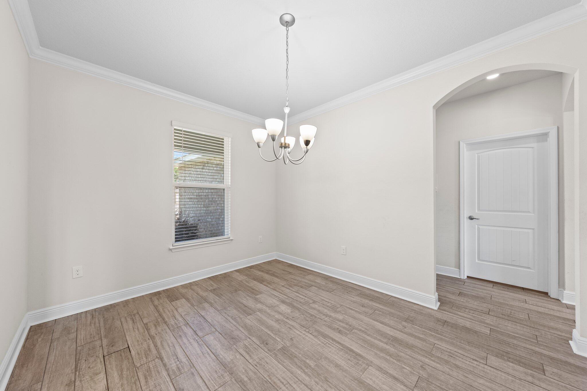 91 Sweet Tea Lane Freeport, FL 32439 - Photo 21 of 80 a view of a room with wooden floor and chandelier