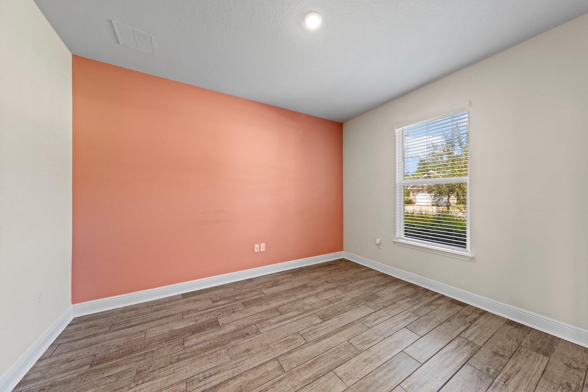 91 Sweet Tea Lane Freeport, FL 32439 - Photo 22 of 80 a view of an empty room with wooden floor and a window