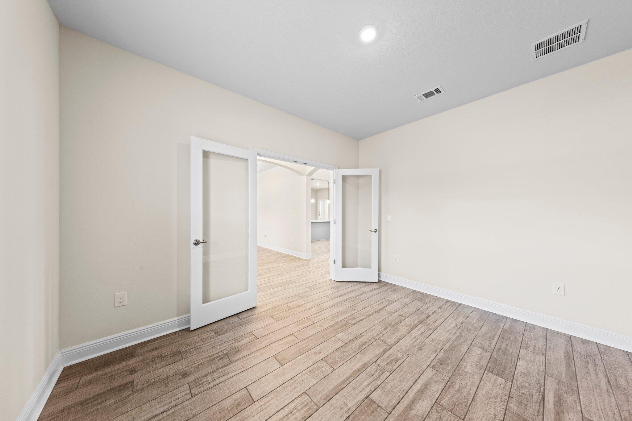 91 Sweet Tea Lane Freeport, FL 32439 - Photo 23 of 80 a view of an empty room and wooden floor
