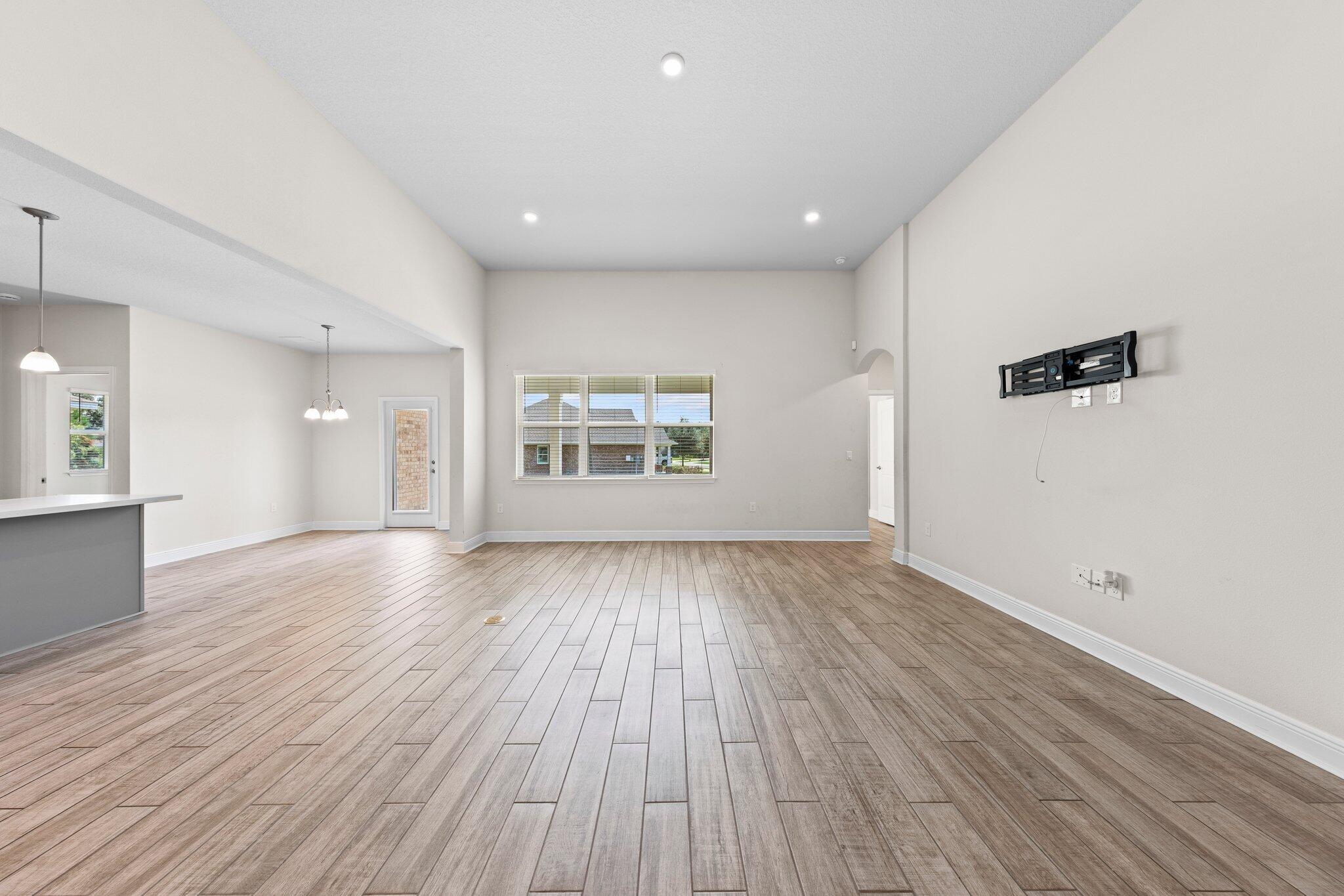 91 Sweet Tea Lane Freeport, FL 32439 - Photo 24 of 80 an empty room with wooden floor and windows