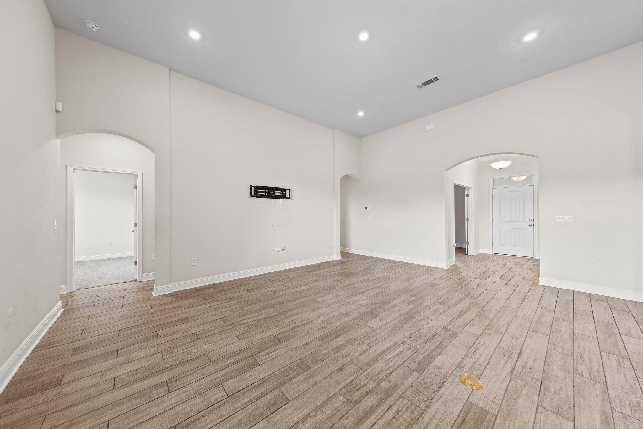 91 Sweet Tea Lane Freeport, FL 32439 - Photo 29 of 80 an empty room with wooden floor and mirror