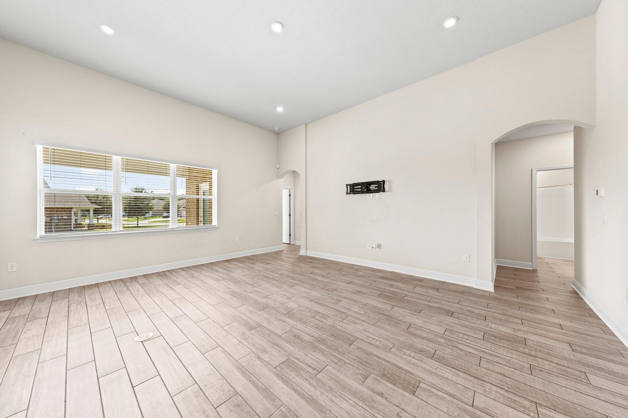 91 Sweet Tea Lane Freeport, FL 32439 - Photo 31 of 80 an empty room with wooden floor and windows