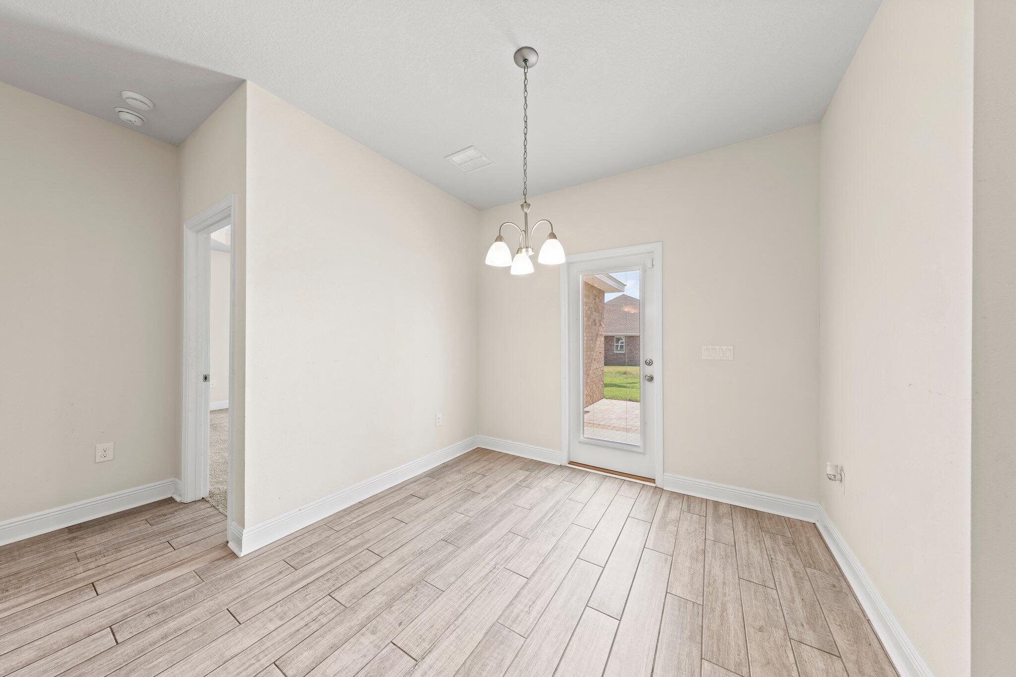 91 Sweet Tea Lane Freeport, FL 32439 - Photo 32 of 80 wooden floor in an empty room with a window