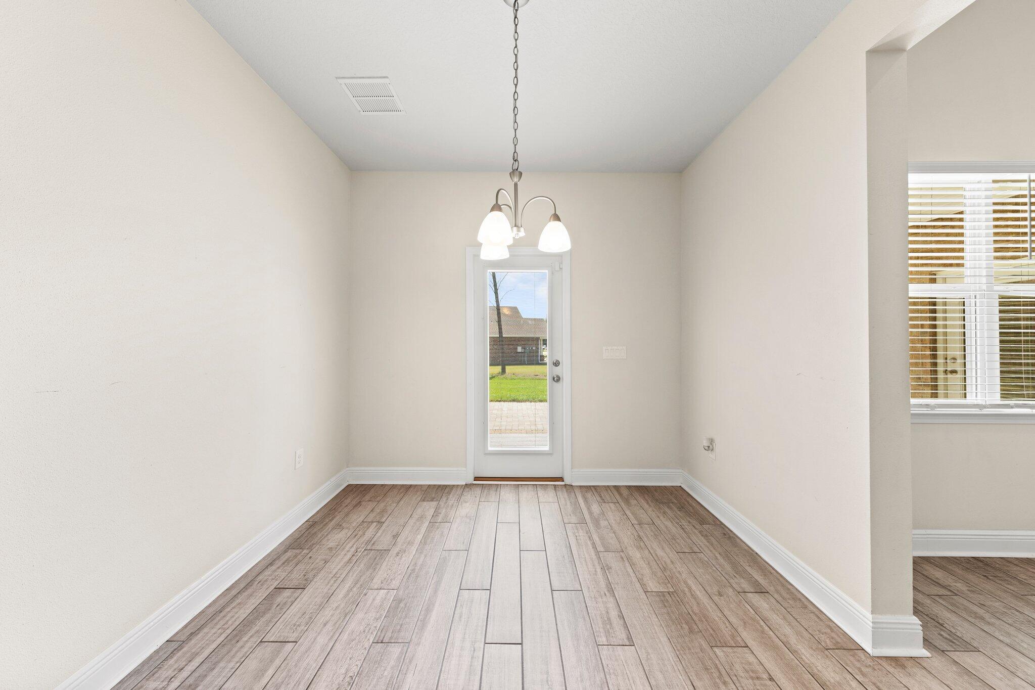 91 Sweet Tea Lane Freeport, FL 32439 - Photo 33 of 80 a view of a room with wooden floor staircase and a kitchen view
