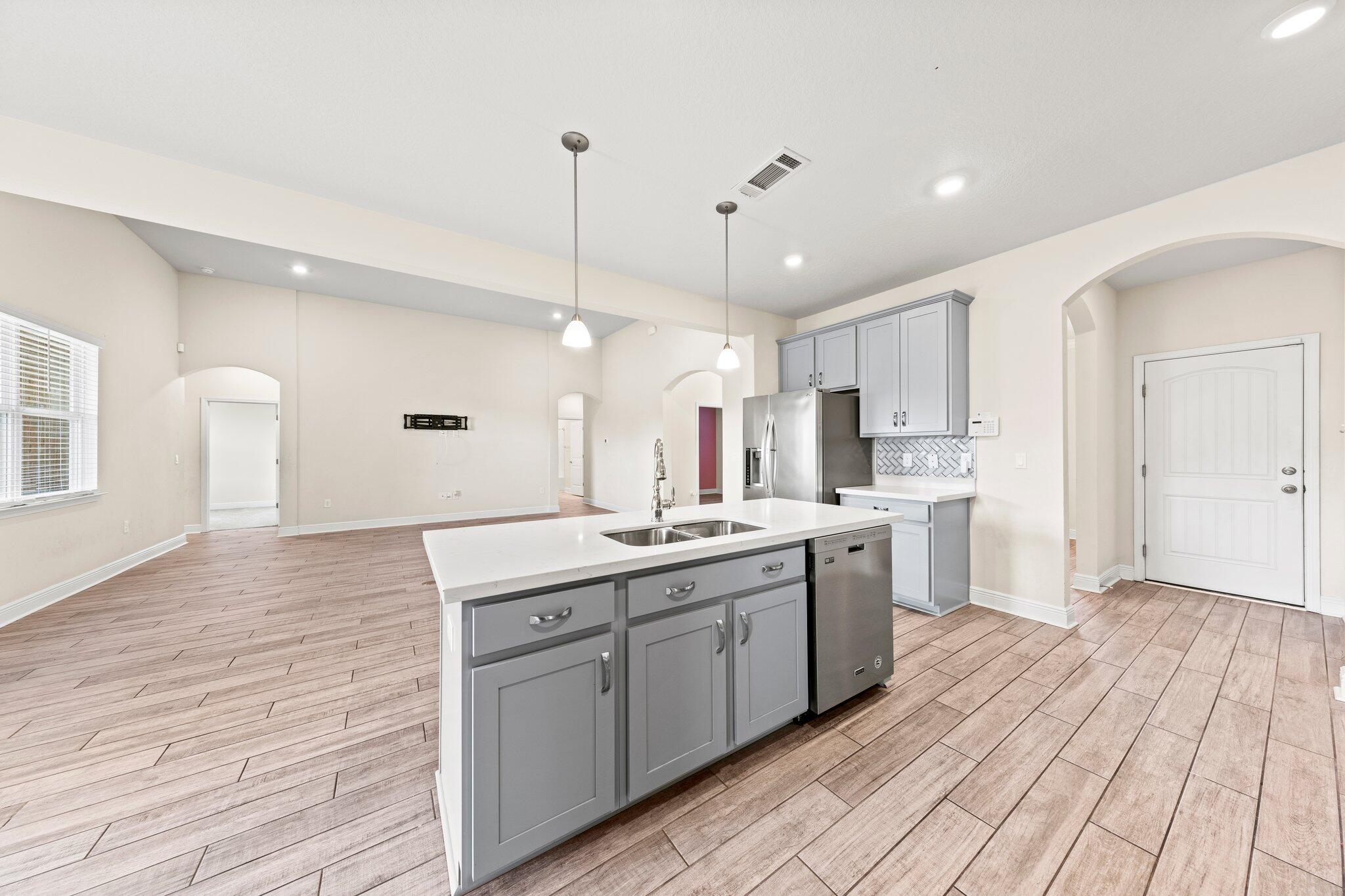 91 Sweet Tea Lane Freeport, FL 32439 - Photo 39 of 80 a large kitchen with stainless steel appliances kitchen island a large island in the center