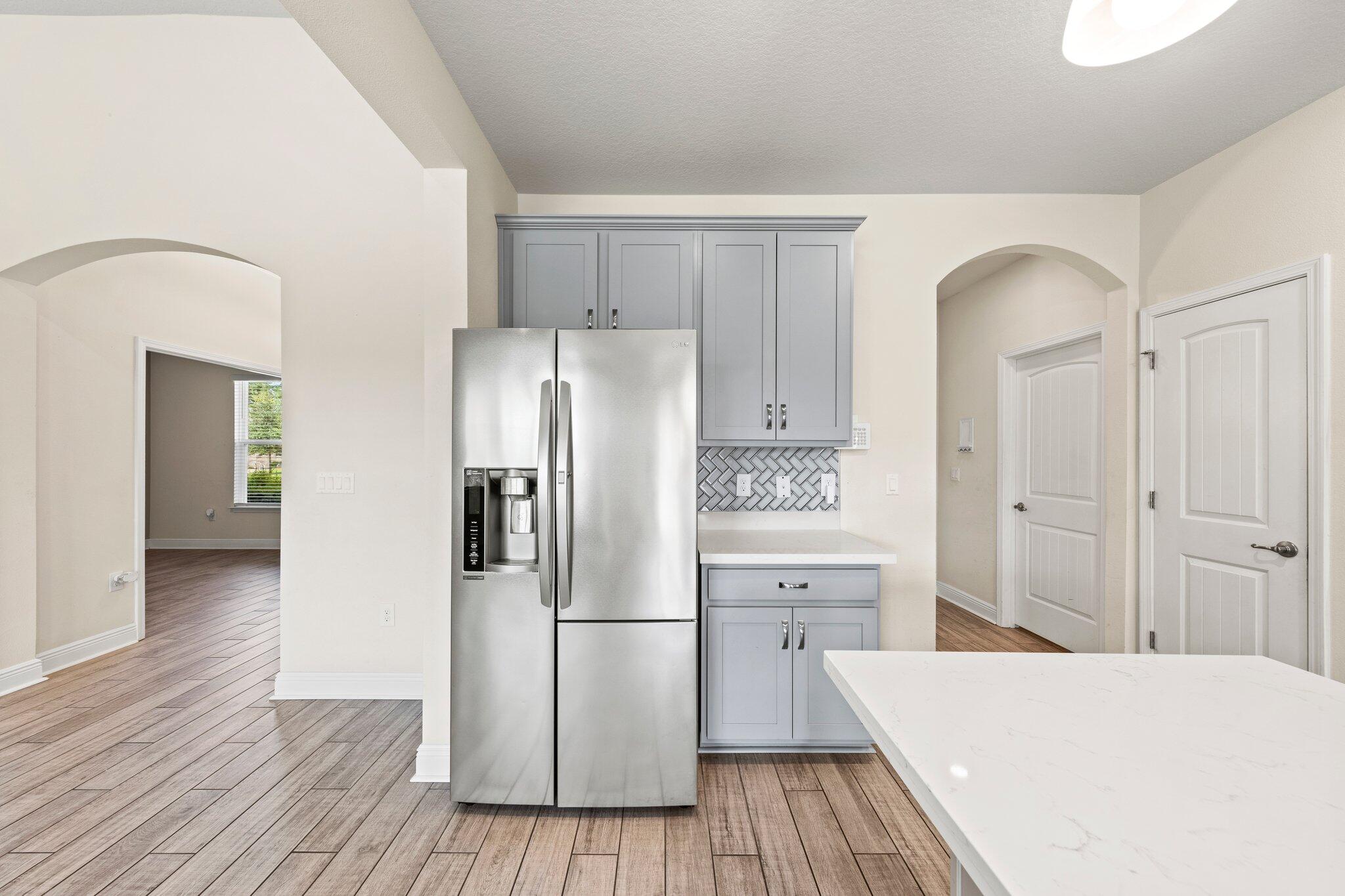91 Sweet Tea Lane Freeport, FL 32439 - Photo 42 of 80 a kitchen with a refrigerator a sink and cabinets