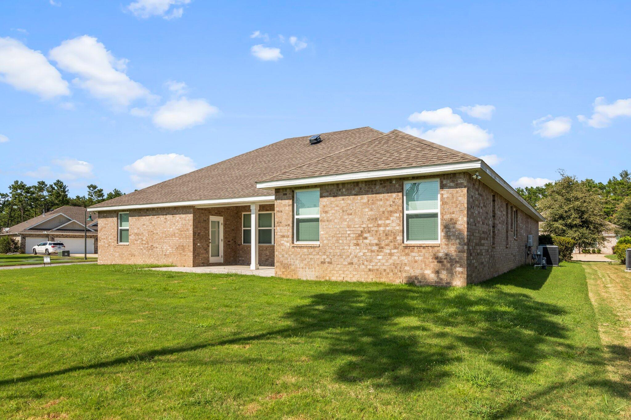 91 Sweet Tea Lane Freeport, FL 32439 - Photo 70 of 80 a front view of house with yard and green space