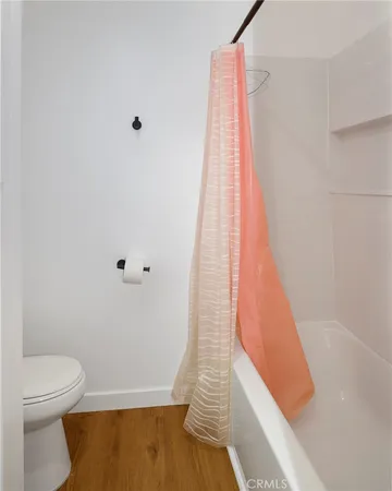 a bathroom with a toilet and a bathtub