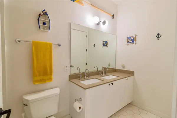 a bed room with a bed window and a flat screen tv