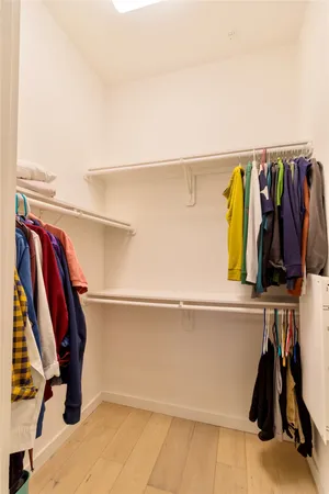 a bathroom with a bathtub shower sink mirror and a toilet