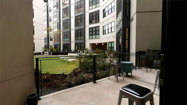 a view of a house with a yard and sitting area