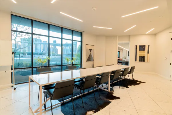 a living room with furniture and large windows