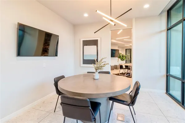 a dining room with furniture and window