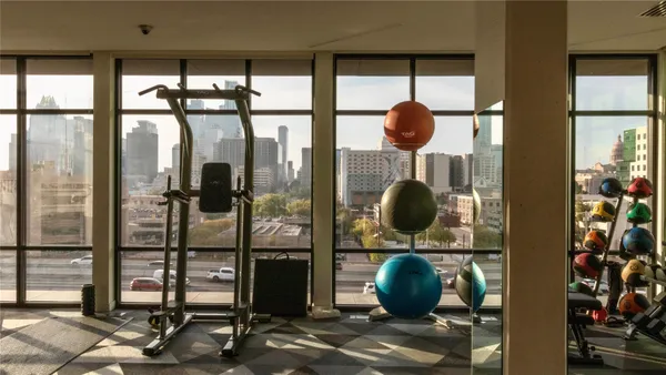 a bathroom with a mirror and a glass door