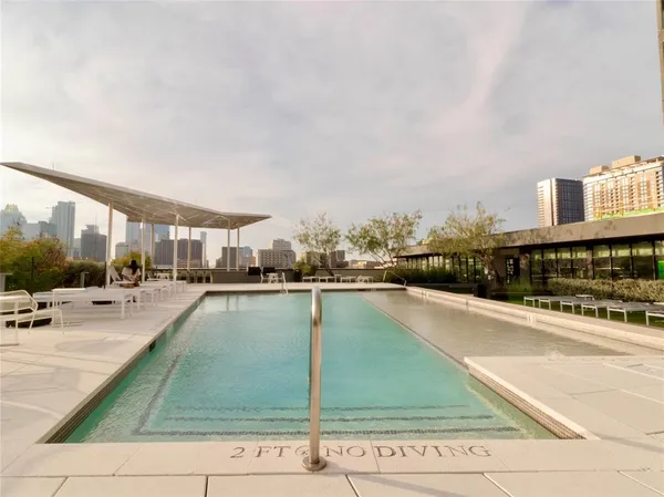 a view of a swimming pool with outdoor seating