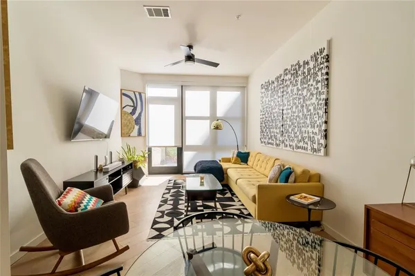 a kitchen with a refrigerator a dining table and chairs