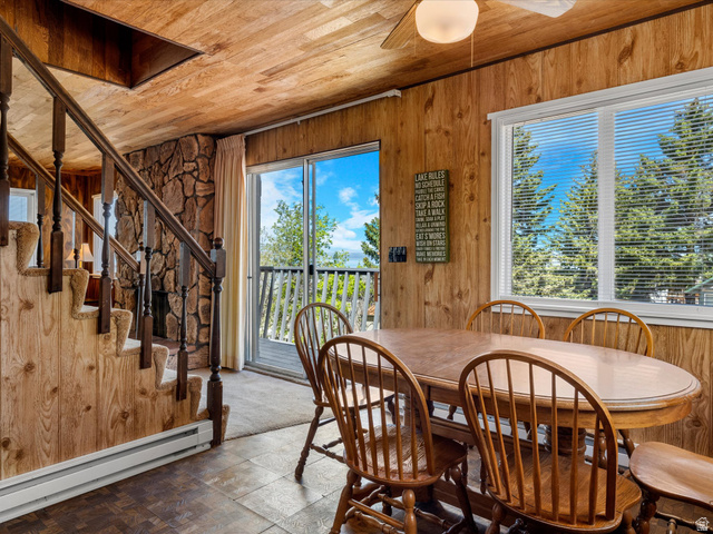 85 B Street, Unit 22 St. Charles, ID 83272 - Photo 20 of 35 Interior space featuring wood walls and ceiling, a stone fireplace, and a large sliding glass door opening to an outdoor deck