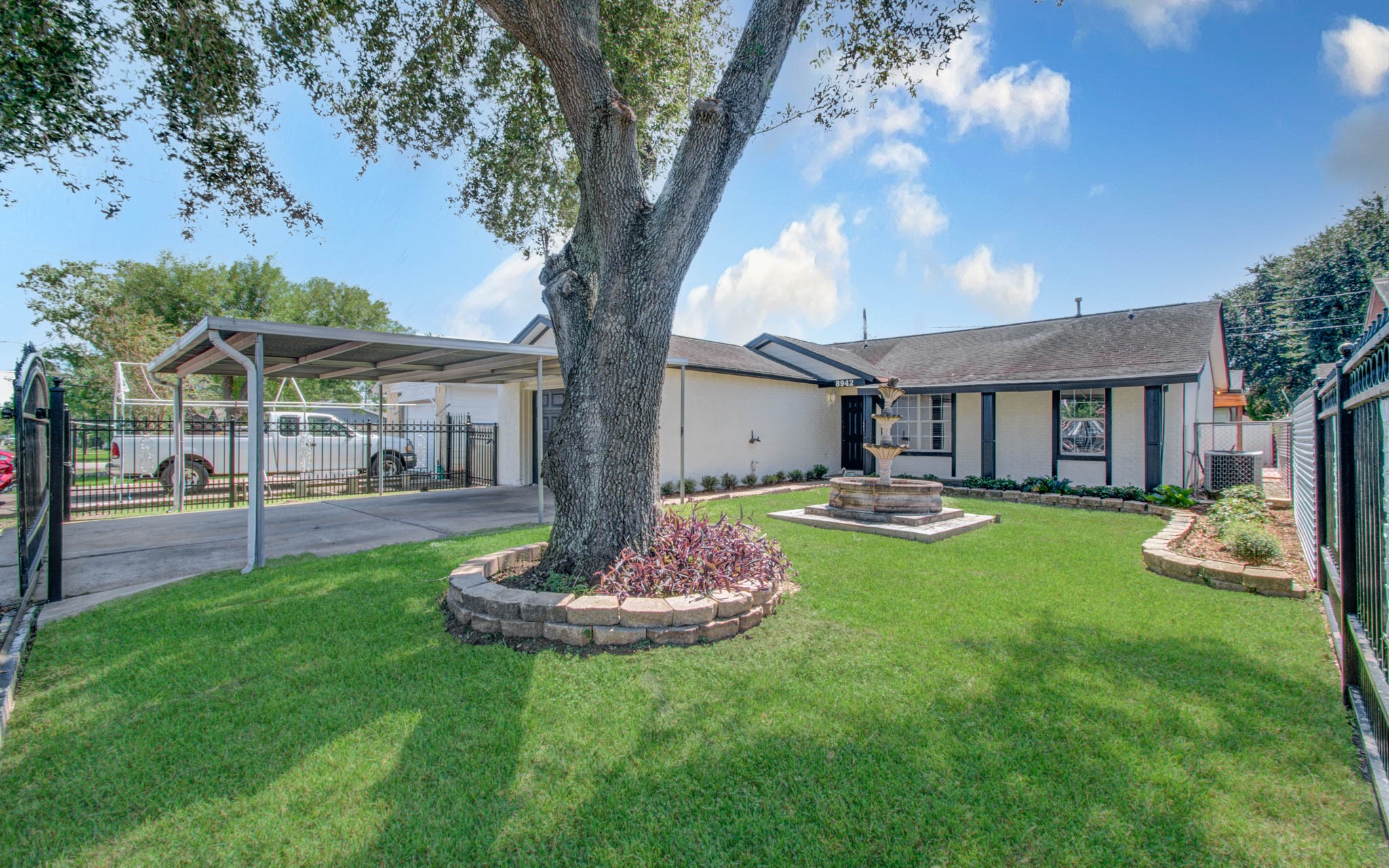 8942 Judwin Street Houston, TX 77075 - Photo 2 of 21 a front view of a house with swimming pool yard and patio