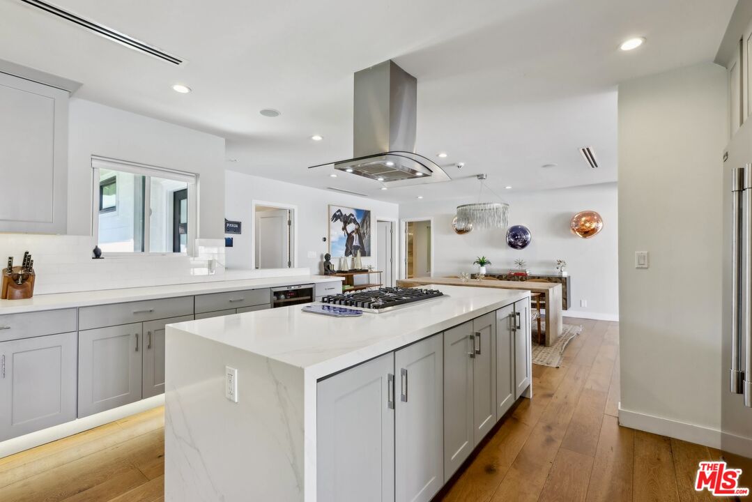 1506 Walgrove Avenue Los Angeles, CA 90066 - Photo 11 of 25 a kitchen with a sink stove and cabinets