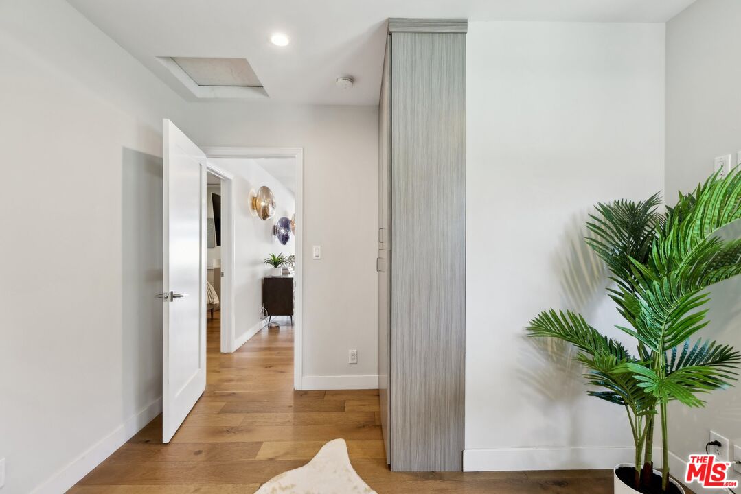 1506 Walgrove Avenue Los Angeles, CA 90066 - Photo 14 of 25 a view of a hallway with plants and wooden floor