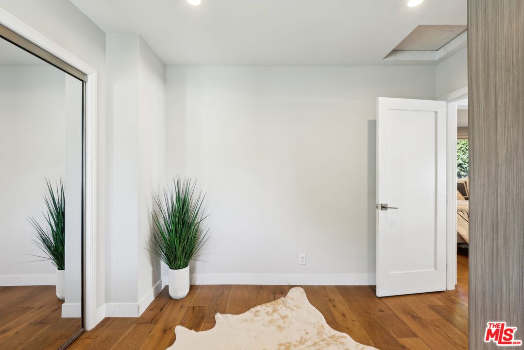 1506 Walgrove Avenue Los Angeles, CA 90066 - Photo 15 of 25 a view of a hallway with wooden floor and a potted plant