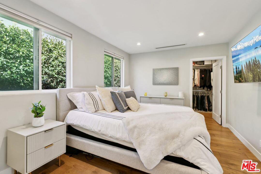 1506 Walgrove Avenue Los Angeles, CA 90066 - Photo 16 of 25 a bedroom with a large bed and potted plant