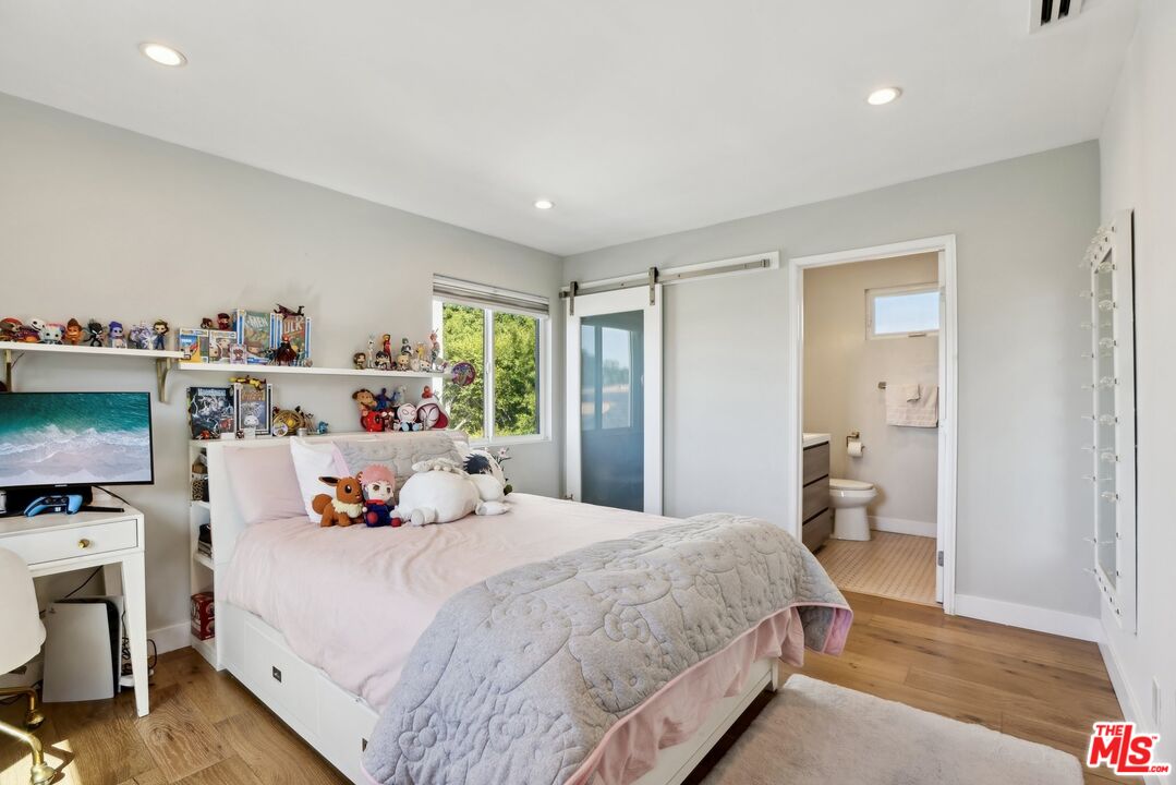 1506 Walgrove Avenue Los Angeles, CA 90066 - Photo 20 of 25 a bedroom with a bed and a view of kitchen