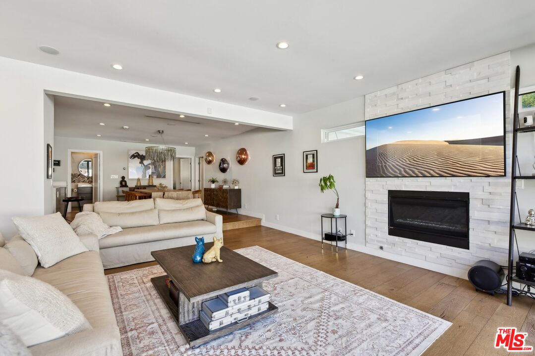1506 Walgrove Avenue Los Angeles, CA 90066 - Photo 5 of 25 a living room with furniture and a fireplace