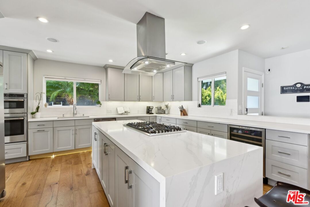 1506 Walgrove Avenue Los Angeles, CA 90066 - Photo 7 of 25 a kitchen with a sink stove cabinets and refrigerator