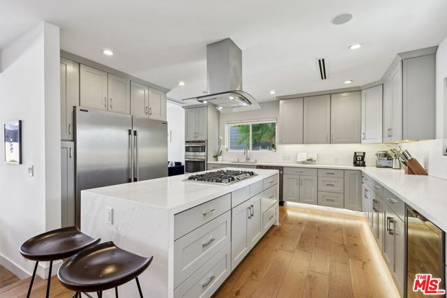 a kitchen with a stove a refrigerator and a sink