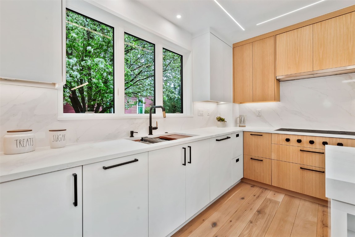 24 Maple Street Steamboat Springs, CO 80487 - Photo 9 of 49 a kitchen with sink cabinets and wooden floor