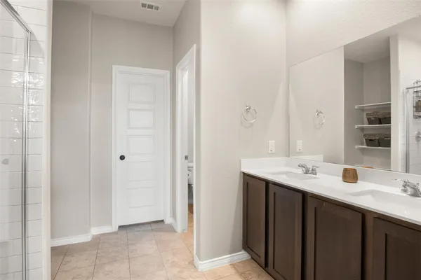 a bathroom with a double vanity sink and mirror