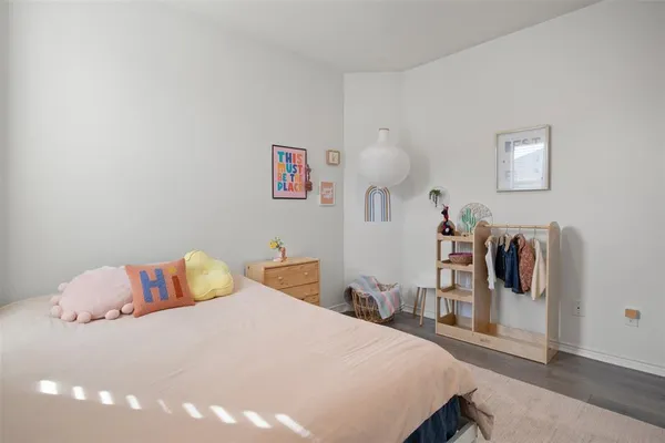 a bedroom with a bed and dresser