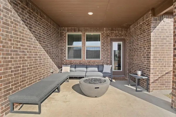 a view of a patio with table and chairs and wooden fence