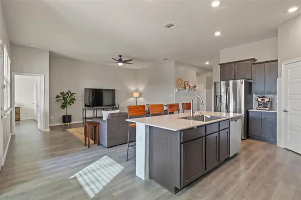 a kitchen with a sink stove and refrigerator