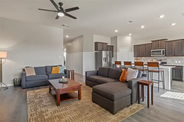 a living room with furniture and kitchen view