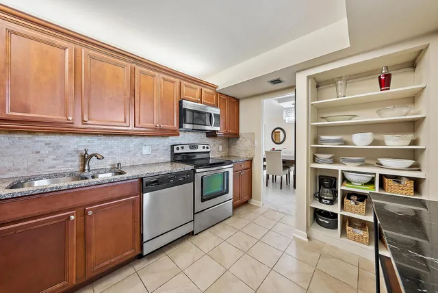 a kitchen with stainless steel appliances granite countertop a stove and cabinets