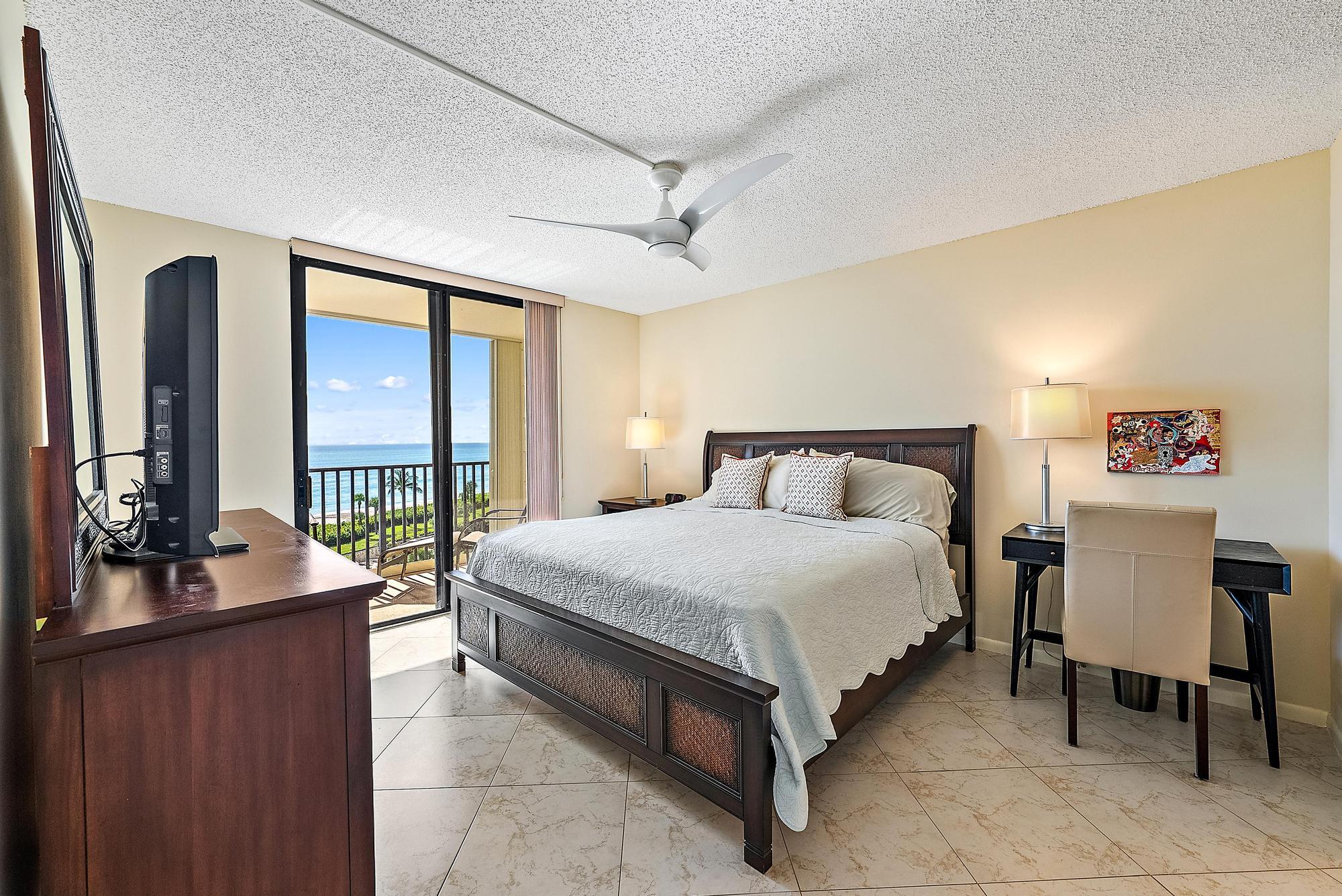 400 Ocean Trail Way, Unit 707 Jupiter, FL 33477 - Photo 12 of 34 a bedroom with a bed and a large window