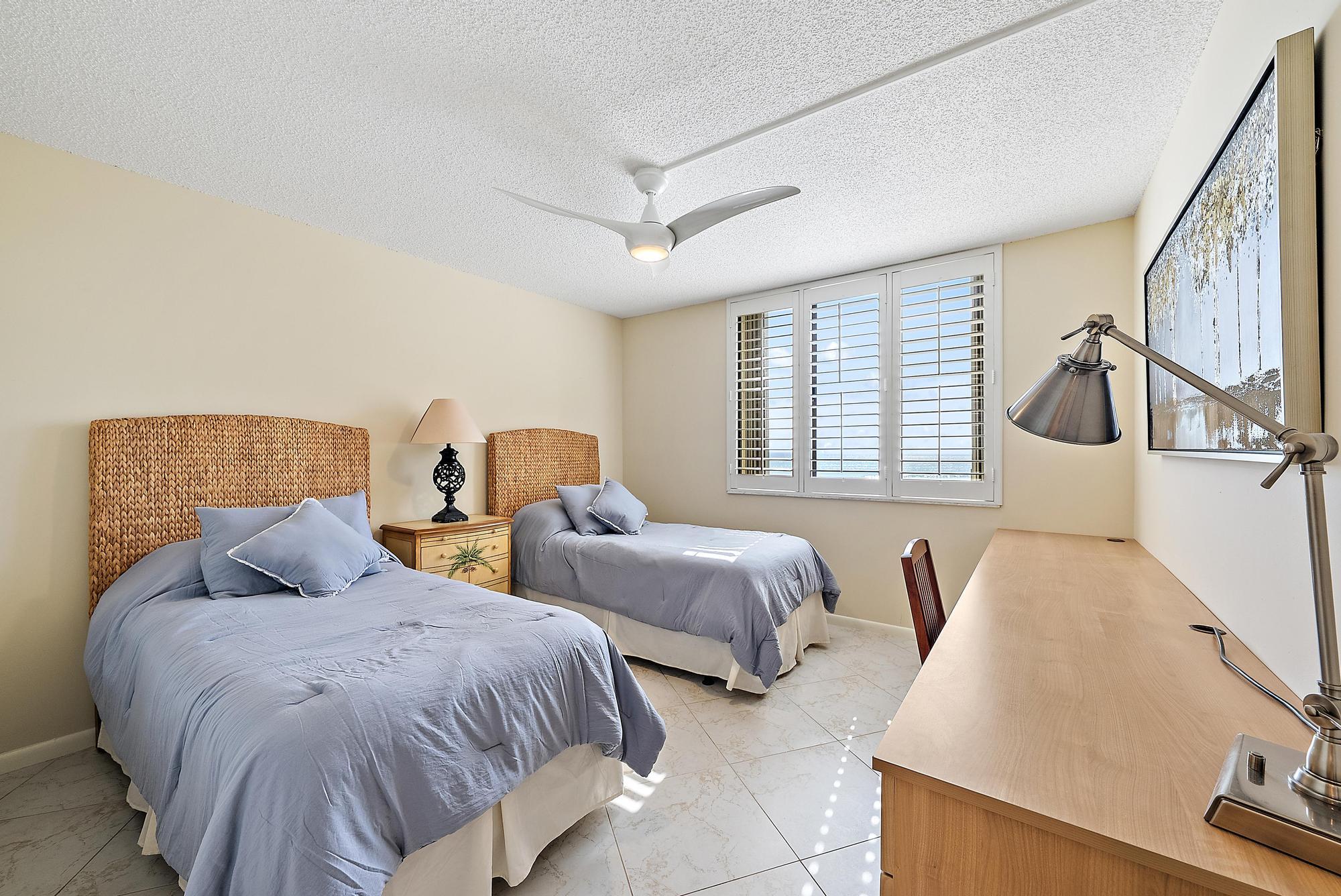 400 Ocean Trail Way, Unit 707 Jupiter, FL 33477 - Photo 16 of 34 a bedroom with two beds and painting on the wall