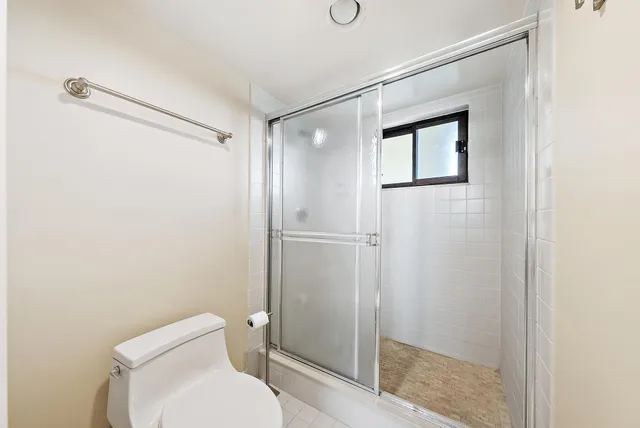 a bathroom with a toilet and a shower